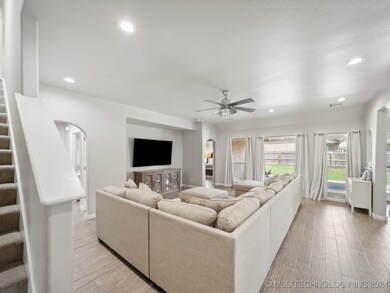 large living with wall of windows open to kitchen