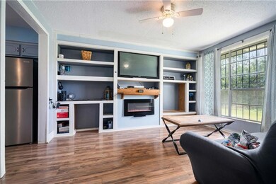 Living area with a electric fireplace, wood finish