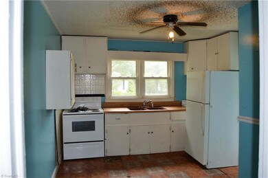 Kitchen with nice view of the front yard area, tile flooring, and good amount of cabinet space.