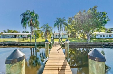 Dock area with a yard and a water view
