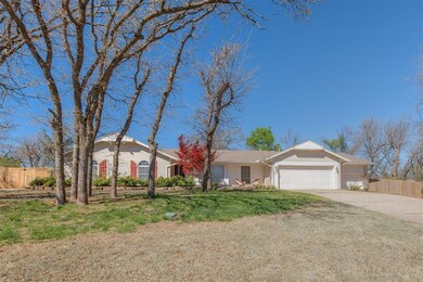 Ranch-style house featuring a garage and a front y