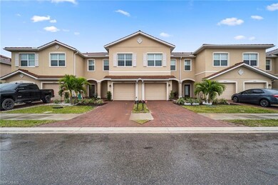 View of property with driveway, stucco siding, a g
