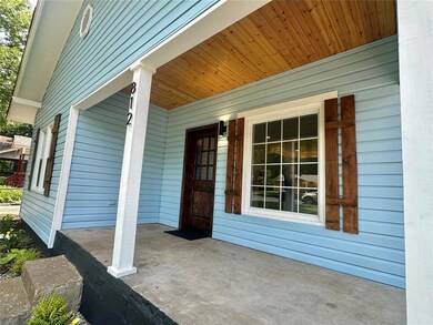 View of exterior entry featuring a porch