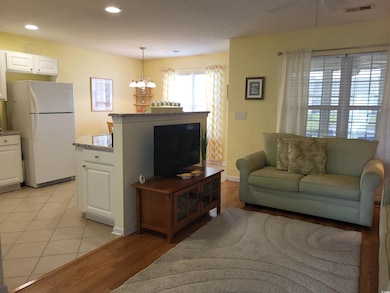Living room featuring a chandelier, light tile pat