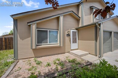 Mid-century home featuring an attached garage and driveway