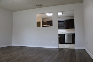 Living room with dark wood-style floors and ceiling fan