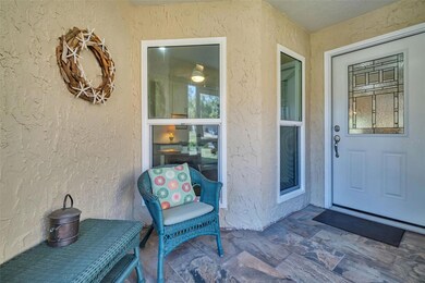 Welcoming screened front entryway & updated hurricane impact windows throughout~