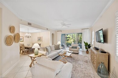 Living area featuring crown molding, light tile pa