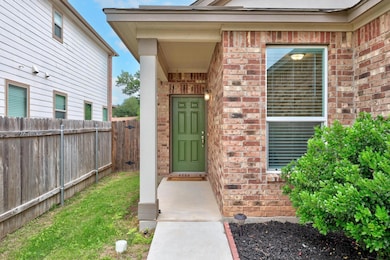 View of exterior entry featuring brick siding and
