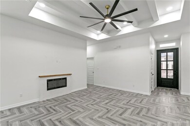 Unfurnished living room featuring ceiling fan