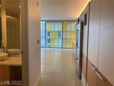 Hall featuring light tile patterned floors and flo