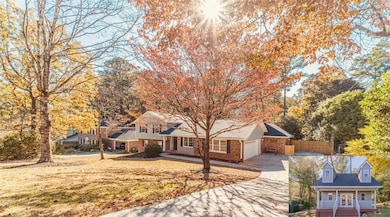 Front of home w/photo of cottage located in back