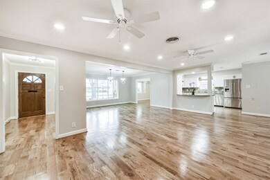 This spacious open-concept living area features ha