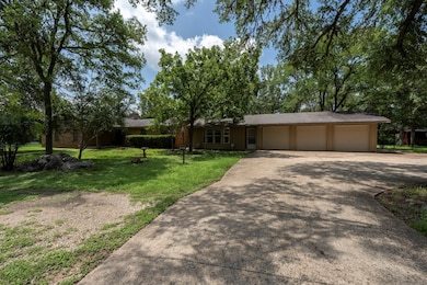 View of front of house with concrete driveway, a 