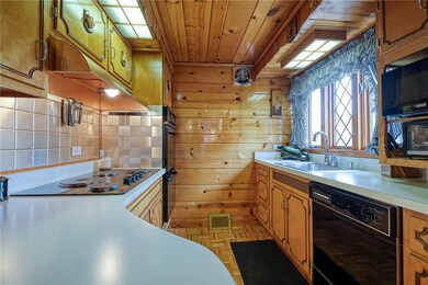 The kitchen offers double ovens, electric cooktop