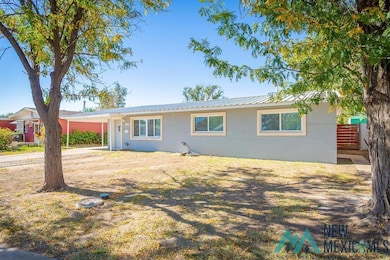 Ranch-style home with an attached carport and a metal roof