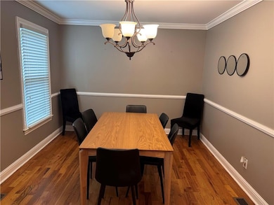 Dining room featuring baseboards, ornamental moldi