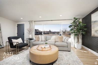 Sitting room with wood finished floors, recessed lighting, and wood walls