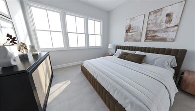 Bedroom featuring baseboards and light carpet