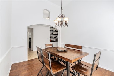 Dining space with arched walkways, wood finished 
