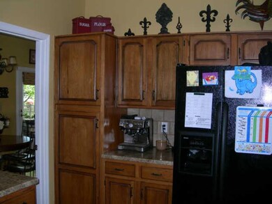 Kitchen cabinets with black refrigerator