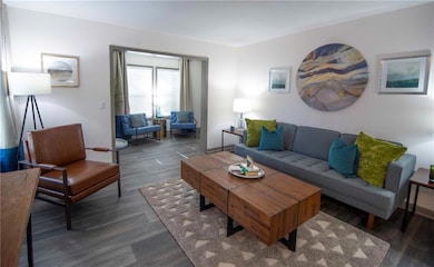 Living room with dark wood-type flooring