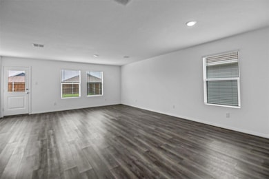 Spare room featuring visible vents, baseboards, an