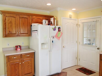 More work & storage space on this side, a pantry & door to the 2 car garage 