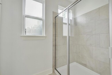 Full bathroom with a shower stall