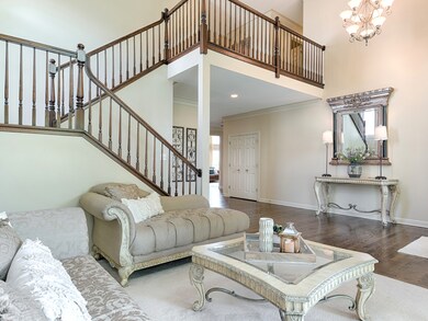 2 STORY LIVING ROOM WITH AN OPEN STAIRCASE
