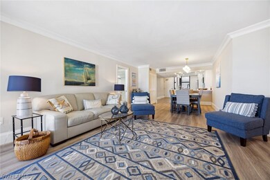 Living room featuring ornamental molding and hardw