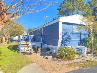 View of home's exterior featuring a yard and a woo