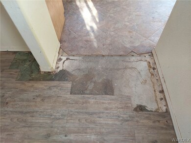 damaged flooring in kitchen & living area