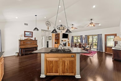 Kitchen featuring a kitchen island, open floor pl