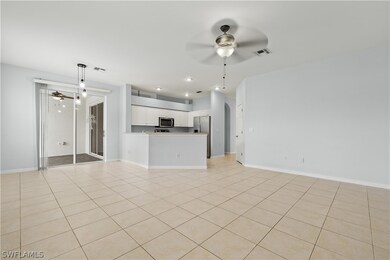 Unfurnished living room with ceiling fan and light tile patterned floors