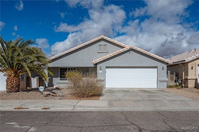 View of front facade with an attached garage, a ti
