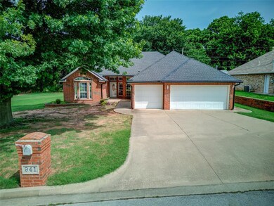 View of front of house featuring brick siding, a front yard, concrete driveway, an attached garage, and a shingled roof