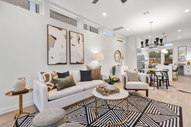 Living area featuring a ceiling fan, visible vent