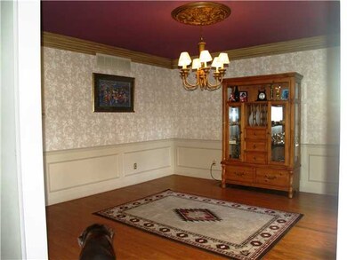 Elegant wall paper and heavy moldings enhance the 