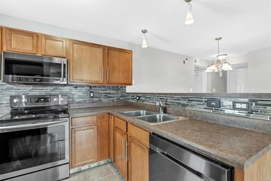 Lovely kitchen with glass tile backsplash is fille