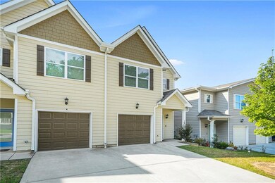 View of front of home featuring an attached garage and driveway