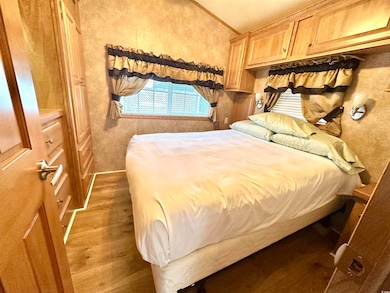 Bedroom featuring light wood-style floors and vaulted ceiling