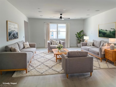 Living room with light wood-type flooring, a ceil