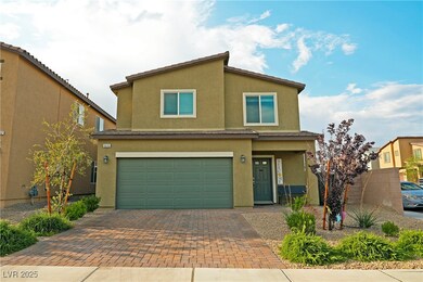 View of front of home featuring a garage and drive
