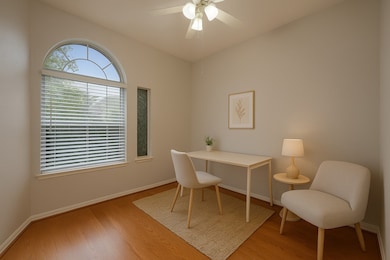 Secondary bedroom virtually staged as an office.