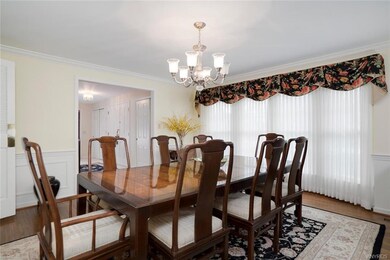 Lovely dining room features gleaming hardwood floo