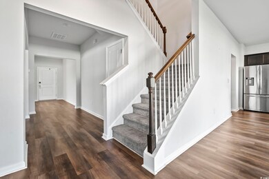 Staircase featuring wood finished floors and baseboards