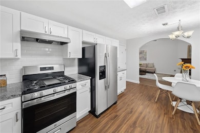 Kitchen features white shaker style caabinets