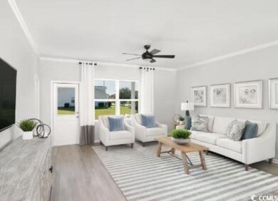 Living room with crown molding, ceiling fan, and h
