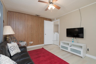 Living area featuring wood walls, wood finished fl